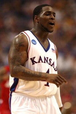MINNEAPOLIS - MARCH 22:  Sherron Collins #4 of the Kansas Jayhawks reacts on court in the final minutes of Kansas' 60-43 win against the Dayton Flyers during the second round of the NCAA Division I Men's Basketball Tournament at the Hubert H. Humphrey Met