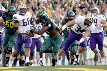 EUGENE, OR - AUGUST 30:  LaMichael James #21 of the Oregon Ducks carries the ball as he is grabbed by Tripper Johnson #34 of the Washington Huskies at Autzen Stadium on August 30, 2008 in Eugene, Oregon. (Photo by Jonathan Ferrey/Getty Images)