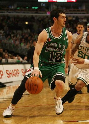 CHICAGO - MARCH 17: Kirk Hinrich #12 of the Chicago Bulls dribbles past Eddie House #50 of the Boston Celtics on March 17, 2009 at the United Center in Chicago, Illinois. The Bulls defeated the Celtics 127-121. NOTE TO USER: User expressly acknowledges an