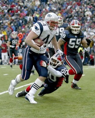 ORCHARD PARK, NY - DECEMBER 28: Heath Evans #44 of the New England Patriots runs after a catch for 12 yards as Ko Simpson #30 of the Buffalo Bills  makes the tackle at Ralph Wilson Stadium on December 28, 2008 in Orchard Park, New York. The Patriots won 1