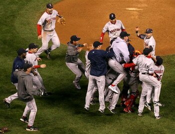 DENVER - OCTOBER 28:  (L-R) David Ortiz #34, Eric Hinske #12, Mike Lowell #25, Julio Lugo #23, Curt Schilling #38 and Dustin Pedroia #19 of the Boston Red Sox celebrate after defeating the Colorado Rockies in Game Four of the 2007 World Series at Coors Fi