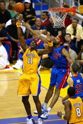 LOS ANGELES - JUNE 8:  Rasheed Wallace #30 of the Detroit Pistons blocks Karl Malone #11 of the Los Angeles Lakers in Game 2 of the 2004 NBA Finals on June 8, 2004 at Staples Center in Los Angeles, California.  NOTE TO USER: User expressly acknowledges an
