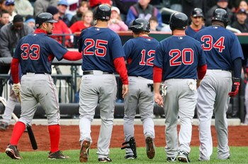 NEW YORK - APRIL 04:  Jason Varitek #33 of the Boston Red Sox congratulates teammate Jed Lowrie #12 after his first inning grand slam that scored Mike Lowell #25, Kevin Youkilis #20, and David Ortiz #34  against the New York Mets on April 4, 2009 at Citi 