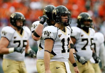 MIAMI - OCTOBER 25:  Quarterback Riley Skinner #11 of the Wake Forest Demon Decons walks with the offense off the field after failing to convert on a fourth down attempt against the Miami Hurricanes at Dolphin Stadium on October 25, 2008 in Miami, Florida