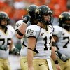 MIAMI - OCTOBER 25:  Quarterback Riley Skinner #11 of the Wake Forest Demon Decons walks with the offense off the field after failing to convert on a fourth down attempt against the Miami Hurricanes at Dolphin Stadium on October 25, 2008 in Miami, Florida