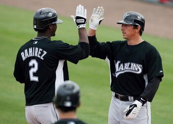 JUPITER, FL - FEBRUARY 25:  Hanley Ramirez #2 of the Florida Marlins is congratulated by John Baker #21 after driving home Baker with a two run home run in the sixth inning against the St. Louis Cardinals during a spring training game at Roger Dean Stadiu
