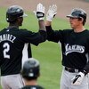 JUPITER, FL - FEBRUARY 25:  Hanley Ramirez #2 of the Florida Marlins is congratulated by John Baker #21 after driving home Baker with a two run home run in the sixth inning against the St. Louis Cardinals during a spring training game at Roger Dean Stadiu