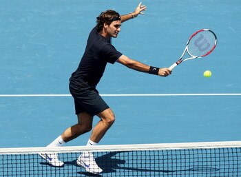 MELBOURNE, AUSTRALIA - JANUARY 14:  Roger Federer of Switzerland plays a backhand volley during his match against Carlos Moya of Spain during day one of the AAMI Classic at the Kooyong Lawn Tennis Club on January 14, 2009 in Melbourne, Australia.  (Photo 