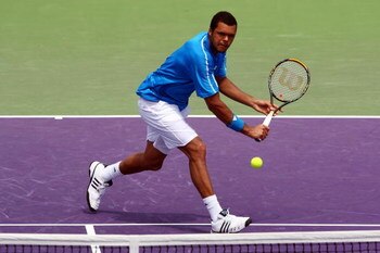 KEY BISCAYNE, FL - MARCH 31:  Jo-Wilfried Tsonga of France returns a shot against Gilles Simon of France during day nine of the Sony Ericsson Open at the Crandon Park Tennis Center on March 31, 2009 in Key Biscayne, Florida.  (Photo by Clive Brunskill/Get