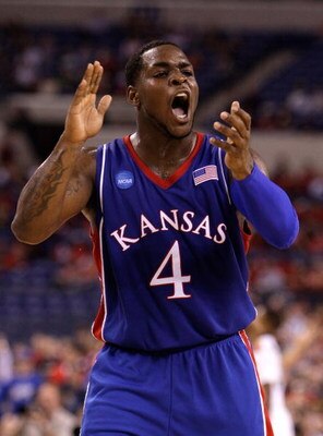 INDIANAPOLIS - MARCH 27:  Sherron Collins #4 of the Kansas Jayhawks reacts in the first half against the Michigan State Spartans during the third round of the NCAA Division I Men's Basketball Tournament at the Lucas Oil Stadium on March 27, 2009 in Indian