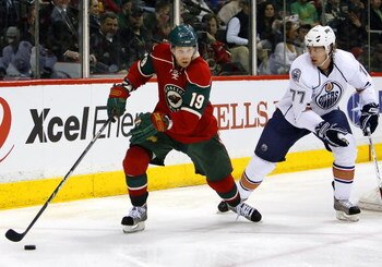 ST. PAUL, MN - MARCH 22:  Stephane Veilleux #19 of the Minnesota Wild skates past Tom Gilbert #77 of the Edmonton Oilers March 22, 2009 at the Xcel Energy Center in St. Paul, Minnesota. Minnesota won, 3-0. (Photo by Scott A. Schneider/Getty Images)