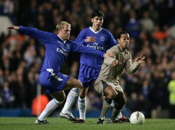 LONDON - MARCH 8: Eidur Gudjohnsen of Chelsea battles with Ronaldinho of Barcelona during the UEFA Champions League, First Knockout Round, Second Leg match between Chelsea and Barcelona at Stamford Bridge on March 8, 2005 in London, England.  (Photo by Be