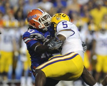 GAINESVILLE, FL - OCTOBER 11: Safety Will Hill #10 of the University of Florida Gators tackles running back Keiland Williams #5 of the LSU Tigers at Ben Hill Griffin Stadium on October 11, 2008 in Gainesville, Florida.  (Photo by Al Messerschmidt/Getty Im