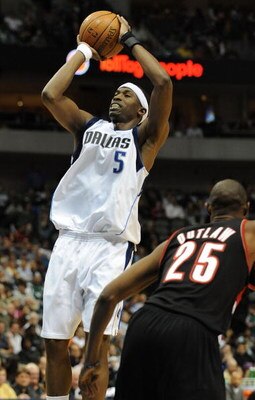 DALLAS - FEBRUARY 04:  Josh Howard #5 of the Dallas Mavericks takes a shot against Travis Outlaw #25 of the Portland Trail Blazers on February 4, 2009 at American Airlines Center in Dallas, Texas.  NOTE TO USER: User expressly acknowledges and agrees that