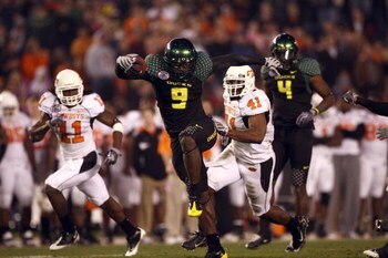 SAN DIEGO, CA - DECEMBER 30:   Runningback LeGarrette Blount #9 of the University of Oregon Ducks hurdles a player en route to a touchdown during his team's 42-31 win over the Oklahoma State University Cowboys in the Pacific Life Holiday Bowl at Qualcomm 