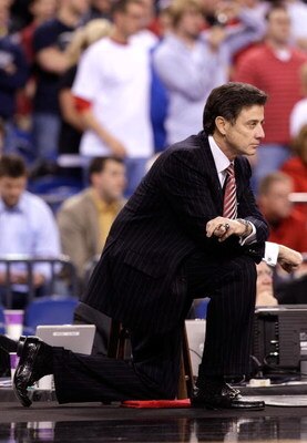 INDIANAPOLIS - MARCH 27:  Head coach Rick Pitino of the Louisville Cardinals kneels on the court as he looks on against the Arizona Wildcats during the third round of the NCAA Division I Men's Basketball Tournament at the Lucas Oil Stadium on March 27, 20