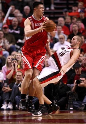 PORTLAND, OR - APRIL 18:  Yao Ming #11 of the Houston Rockets drives against Joel Przybilla #10 of the Portland Trail Blazers during Game One of the Western Conference Quarterfinals of the 2009 NBA Playoffs on April 18, 2009 at the Rose Garden in Portland