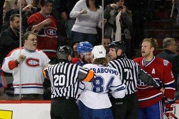 MONTREAL- JANUARY 8:  Guillaume Latendresse #84 and Mike Komisarek #8 of the Montreal Canadiens exchange words with former team mate Mikhail Grabovski #84 of the Toronto Maple Leafs at the Bell Centre on January 08, 2009 in Montreal, Quebec, Canada.   (Ph