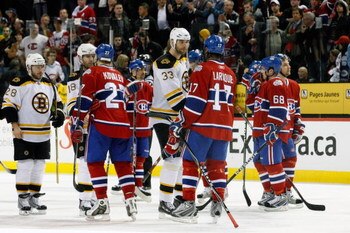 MONTREAL- APRIL 22:  Alexei Kovalev #27 and Georges Laraque #17 of the Montreal Canadiens shake hands with Stephane Yelle #18 and Zdeno Chara #33 of the Boston Bruins after Game Four of the Eastern Conference Quarterfinals of the 2009 Stanley Cup Playoffs