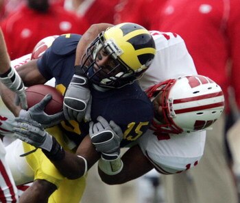 ANN ARBOR, MI - SEPTEMBER 23:  Steve Breaston #15 of the Michigan Wolverines is tackled by DeAndre Levy #11 of the Wisconsin Badgers on September 23, 2006 at Michigan Stadium in Ann Arbor, Michigan. Michigan defeated Wisconsin 27-13.  (Photo by Jonathan D