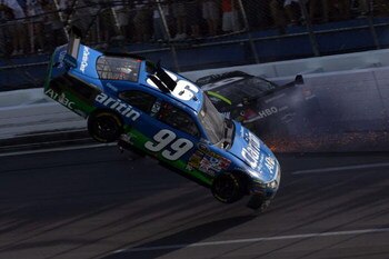 TALLADEGA, AL - APRIL 26:  Carl Edwards, driver of the #99 Claritin Ford goes airborne as Ryan Newman, driver of the #34 Stewart-Haas Racing Chevrolet hits the wall at the end of the NASCAR Sprint Cup Series Aaron's 499 at Talladega Superspeedway on April