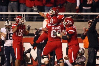 SALT LAKE CITY, UT - NOVEMBER 22:  Brent Casteel #5  of the Utah Utes celebrates with teammates Freddie Brown #88, Zane Beadles #68 and Caleb Schlauderaff #72 during the game against the BYU Cougars at Rice-Eccles Stadium on November 22, 2008 in Salt Lake