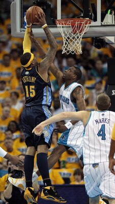 NEW ORLEANS - APRIL 25:  Carmelo Anthony #15 of the Denver Nuggets goes to the basket against Rasual Butler #45 and Sean Marks #4 of the New Orleans Hornets during Game Three of the Western Conference Quarterfinals during the 2009 NBA Playoffs at New Orle