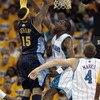 NEW ORLEANS - APRIL 25:  Carmelo Anthony #15 of the Denver Nuggets goes to the basket against Rasual Butler #45 and Sean Marks #4 of the New Orleans Hornets during Game Three of the Western Conference Quarterfinals during the 2009 NBA Playoffs at New Orle