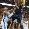 NEW ORLEANS - APRIL 25:  Carmelo Anthony #15 of the Denver Nuggets drives to the basket against David West #30 of the New Orleans Hornets during Game Three of the Western Conference Quarterfinals during the 2009 NBA Playoffs at New Orleans Arena on April 
