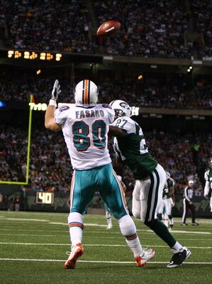 EAST RUTHERFORD, NJ - DECEMBER 28: Anthony Fasano #80 of The Miami Dolphins scores a touchdown against Abram Elam #27 of the New York Jets during their game on December 28, 2008 at Giants Stadium in East Rutherford, New Jersey. (Photo by Al Bello/Getty Im