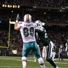 EAST RUTHERFORD, NJ - DECEMBER 28: Anthony Fasano #80 of The Miami Dolphins scores a touchdown against Abram Elam #27 of the New York Jets during their game on December 28, 2008 at Giants Stadium in East Rutherford, New Jersey. (Photo by Al Bello/Getty Im