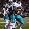 EAST RUTHERFORD, NJ - DECEMBER 28:  Phillip Merling #97 of The Miami Dolphins rumbles in for a touchdown after making an interception thrown by Brett Favre of The New York Jets during their game on December 28, 2008 at Giants Stadium in East Rutherford, N