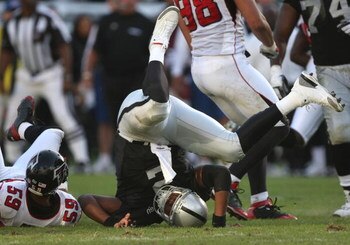 OAKLAND, CA - NOVEMBER 02:  JaMarcus Russell #2 of the Oakland Raiders is hit after throwing the ball against the Atlanta Falcons during an NFL game on November 2, 2008 at the Oakland-Alameda County Coliseum in Oakland, California.  (Photo by Jed Jacobsoh