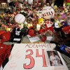 ANAHEIM, CA - APRIL 10:  Fans gather around a makeshift memorial to Los Angeles Angels pitcher Nick Adenhart outside Angel Stadium, after the game against the Boston Red Sox on April 10, 2009 in Anaheim, California. Adenhart and two others were killed in 