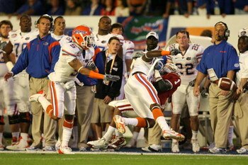 MIAMI - JANUARY 08:  Manuel Johnson #1 of the Oklahoma Sooners can't make a catch along the sideline as he is hit by Major Wright #21 of the Florida Gators during the FedEx BCS National Championship game at Dolphin Stadium on January 8, 2009 in Miami, Flo