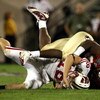 ORLANDO, FL - DECEMBER 27:  Quarterback Dustin Sherer #18 of the Wisconsin Badgers is tackled by Everette Brown #99 of the Florida State Seminoles during the Champs Bowl on December 27, 2008 at the Citrus Bowl in Orlando, Florida.  (Photo by Sam Greenwood