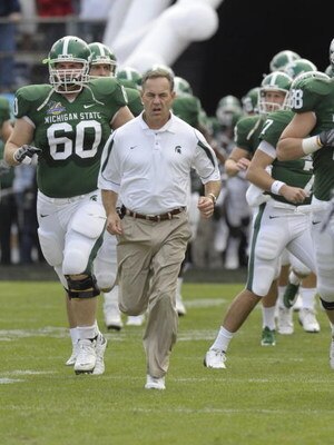 ORLANDO, FL - JANUARY 1: Coach Mark Dantonio of the Michigan State Spartans leads the team to the field for play against the Georgia Bulldogs at the 2009 Capital One Bowl at the Citrus Bowl on January 1, 2009 in Orlando, Florida.  (Photo by Al Messerschmi
