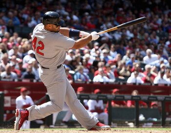PHOENIX - APRIL 15:  Albert Pujols of the St. Louis Cardinals hits an RBI fielder's choice against the Arizona Diamondbacks during the fourth inning of the game at Chase Field April 15, 2009 in Phoenix, Arizona. All Major League Baseball players are weari