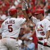 ST. LOUIS, MO - JUNE 8: Jim Edmonds #15 of the St. Louis Cardinals congratulates teammate Albert Pujols #5 after Pujols knocked in three runs against the Milwaukee Brewers at Busch Stadium July 29, 2007 in St. Louis, Missouri.  The Cardinals beat the Brew