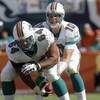 MIAMI, FL - JANUARY 4:  Quarterback Chad Pennington #10 of the Miami Dolphins takes a snap from center Samson Satele #64 against the Baltimore Ravens in an NFL Wildcard Playoff Game at Dolphins Stadium on January 4, 2009 in Miami, Florida.  (Photo by Al M