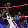CLEVELAND - APRIL 21:  LeBron James #23 of the Cleveland Cavaliers gets fouled hard by Rasheed Wallace #30 and Antonio McDyess #24 of the Detroit Pistons in Game Two of the Eastern Conference Quarterfinals during the 2009 NBA Playoffs at Quicken Loans Are