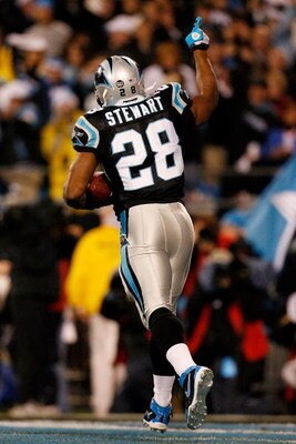 CHARLOTTE, NC - JANUARY 10:  Running back Jonathan Stewart #28 of the Carolina Panthers celebrates scoring a the first touchdown in the first quarter against the Arizona Cardinals during the NFC Divisional Playoff Game on January 10, 2009 at Bank of Ameri