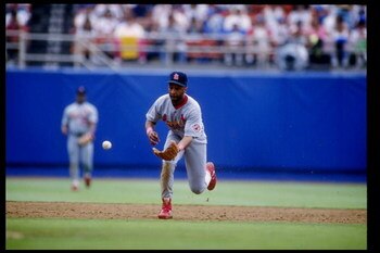 11 Jul 1992: Shortstop Ozzie Smith of the St. Louis Cardinals runs up to scoop up the ball during a game against the Los Angeles Dodgers at Dodger Stadium in Los Angeles, California.