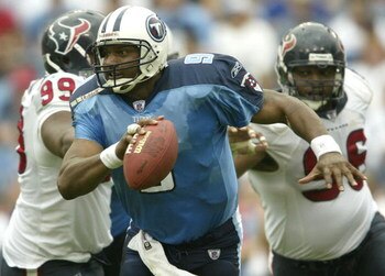 NASHVILLE, TN - OCTOBER 12:  Quarterback Steve McNair #9 of the Tennessee Titans scrambles as Gary Walker #96 of the Houston Texans closes in on October 12, 2003 at The Coliseum in Nashville, Tennessee. The Tennessee Titans defeated the Houston Texans 38-