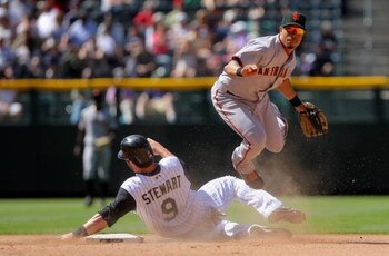DENVER - MAY 07:  Second baseman Emmanual Burriss #7 of the San Francisco Giants gets a force out in Ian Stewart #9 of the Colorado Rockies at second on a grounder by Clint Barmes to Pablo Sandoval in the seventh inning of MLB action at Coors Field on May