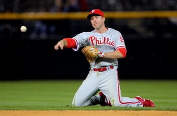DENVER - APRIL 11:  Second baseman Chase Utley #26 of the Philadelphia Phillies goes to his knees to throw out a runner as he plays defense against the Colorado Rockies during MLB action at Coors Field on April 11, 2009 in Denver, Colorado. The Phillies d