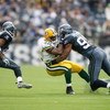 SEATTLE - OCTOBER 12:  Julian Peterson #98 of the Seattle Seahawks tackles DeShawn Wynn #42 of the Green Bay Packers during the game on October 12, 2008 at Qwest Field in Seattle, Washington. The Packers defeated the Seahawks 27-17. (Photo by Otto Greule 