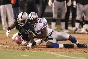 OAKLAND, CA - AUGUST 25: Oakland Raiders Doug Gabriel #85 dives for the ball with Detroit Lions safety Daniel Bullocks  #27in the first half as the Oakland Raiders host the Detroit Lions at McAfee Stadium on August 25, 2006 in Oakland, California. (Photo 