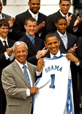 WASHINGTON - MAY 11:  University of North Carolina men's basketball head coach Roy Williams (L) present U.S. President Barack Obama with a team jersey at the White House May 11, 2009 in Washington, DC. The North Carolina Tar Heels are the 2009 National Co