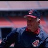 1986:  All time great Atlanta Braves pitcher Phil Niekro, now a coach of the Cleveland Indians, talks with Reggie Jackson.   Mandatory Credit:  Steve Dunn/Allsport